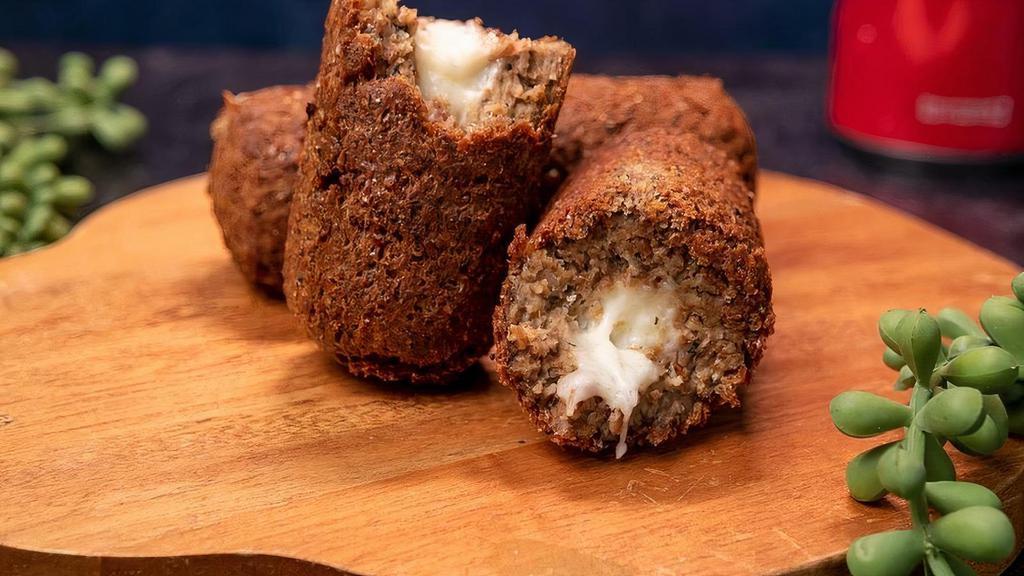 Kibbeh Croquette | Quibe · This traditional-sized kibbeh is a dish made of wheat, fresh spices, and finely ground lean beef, and filled with either beef or cheese.