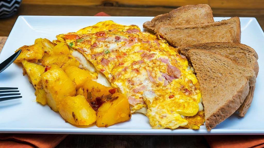Western Omelette · Beaten eggs with tomato, ham, mozzarella, peppers & onions. Comes with toast and home fries.