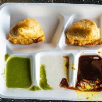 Samosa · Crispy pastry with mashed potatoes and peas.