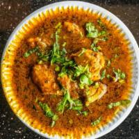 Chicken Curry · Chicken cooked with onion, ginger, garlic having medium-thick sauce, comes with traditional ...
