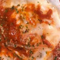 Chicken Parmesan Dinner · Chicken cutlet topped with mozzarella, parmesan, romano baked golden brown over linguine in ...