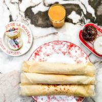 Crêpes À La Crème Fraîche · Three hand rolled crepes served with vanilla bean creme fraiche and your choice of fresh fru...
