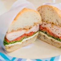 Roasted Turkey Breast · W/ fresh mozzarella, tomatoes, green leaf lettuce, and balsamic vinaigrette.