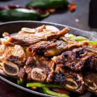 Baby Short Ribs · Korean style grilled marinated baby short ribs, beddig of onion & bell pepper