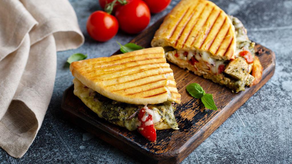 Genovese Panini · Juicy grilled chicken, provolone cheese, roasted peppers, and pesto.