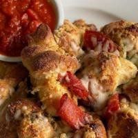 1 Dozen Pepperoni Knots · Garlic knots stuffed with pepperoni and baked with mozzarella cheese.