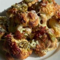 1 Dozen Build Your Own Knots · Garlic knots with baked mozzarella cheese. Add toppings for an additional charge.