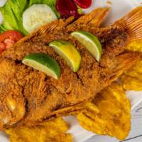 Mojarra Frita · Deep-fried and seasoned tilapia with fried cassava, rice, green plantain, and salad. Served ...