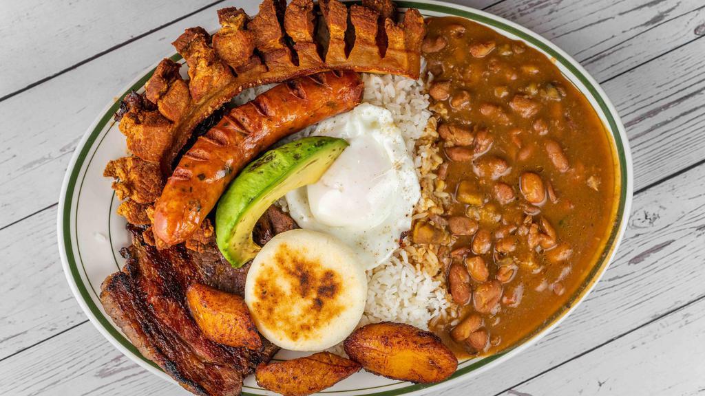 Bandeja Tipica · Grilled steak with rice, beans, crackling, egg, avocado, sweet plantain, and corn cake. Served with a side order.
