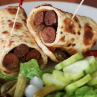 Merguez Sausage Wrap · Three merguez sausages wrapped in pita w/ Sauteed onions & peppers and a yogurt harissa sauce.