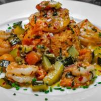 Moroccan Shrimp · Sauteed with tomato couscous, zucchini and citrus vinaigrette.