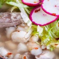 Chicken Pozole · Rich chicken broth with hominy corn, lettuce, cilantro, radishes and onion.