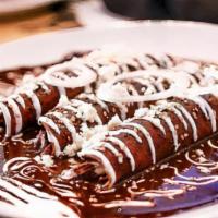 Enchiladas De Mole Poblano · 3 soft corn tortillas rolled and filled with choice of protein. Topped with signature mexica...