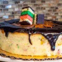 Rainbow Cookie Cheesecake · New York Cheesecake with pieces of our Rainbow cookies baked in, topped with Apricot Jam and...