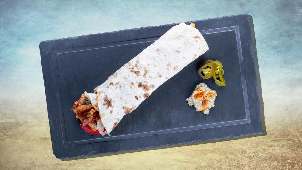 Chicken Wrap Sandwich Loco · First, our wrap is smothered in home-made hummus, topped with finely spiced chicken topped with diced tomatoes, cucumbers, red and green peppers, pickles and Tahini sauce.