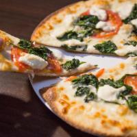 White Pie · Topped with spinach, ricotta cheese, mozzeralla, sliced tomatoes & gresh garlic