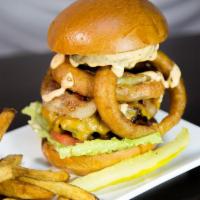 Texas Burger · Stacked with onion rings & bacon, smothered in cheddar cheese and topped with our chipotle r...