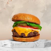 Cheddar Better Burger · American beef patty topped with melted cheese, lettuce, tomato, onion, and pickles. Served o...