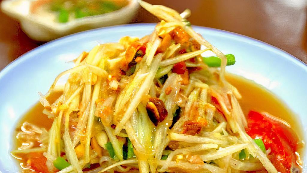 Som Tam Papaya Salad · Shredded Papaya with Spicy Tangy Lime Dressing, Cherry Tomatoes, Long Beans and Ground Peanuts. Gluten Free