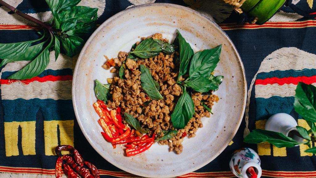 Minced Pork Holy Basil Stir Fry · The dish found on every street corner in Bangkok. Sweet and spicy stir fry of minced pork loaded with peppery Thai Basil. Steamed Jasmine rice on the side