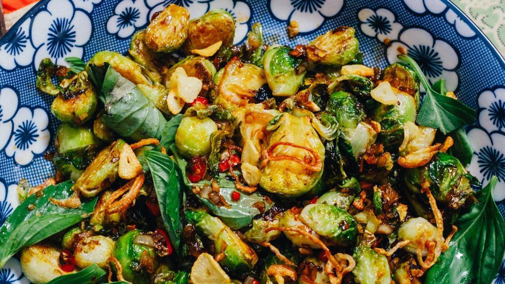 Holy Basil Brussels · A brussely variation on the dish found on every street corner in Bangkok. Sweet and spicy stir fry of crispy brussel sprouts loaded with peppery Thai Basil. Served with steamed jasmine rice