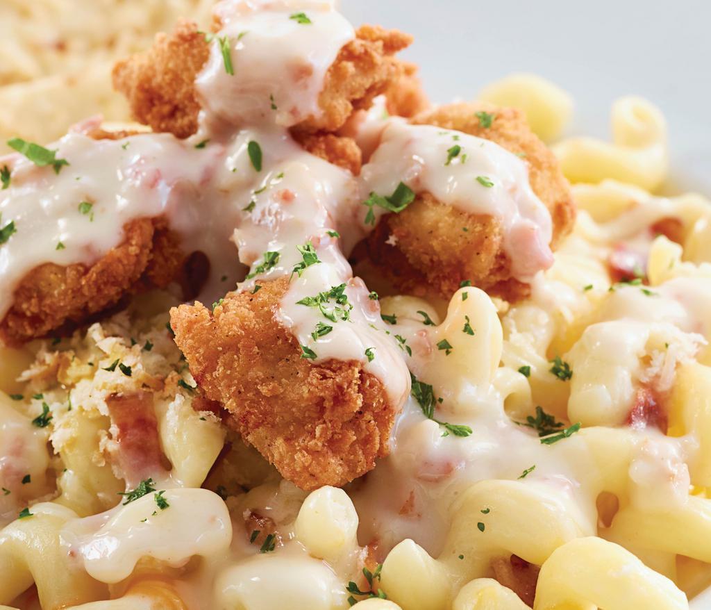 Crispy Chicken Mac ‘N Cheese · Crispy chicken served atop pasta, aged cheddar sauce, and cheeses. 1210 cal.