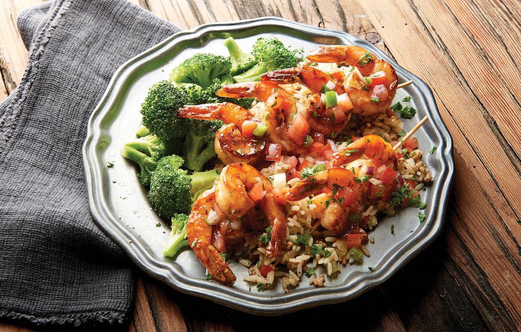 Cajun Grilled Shrimp & Rice · Cajun style grilled shrimp topped with spiced lemon butter sauce. Served with dirty rice and choice of one side. 470 cal.
