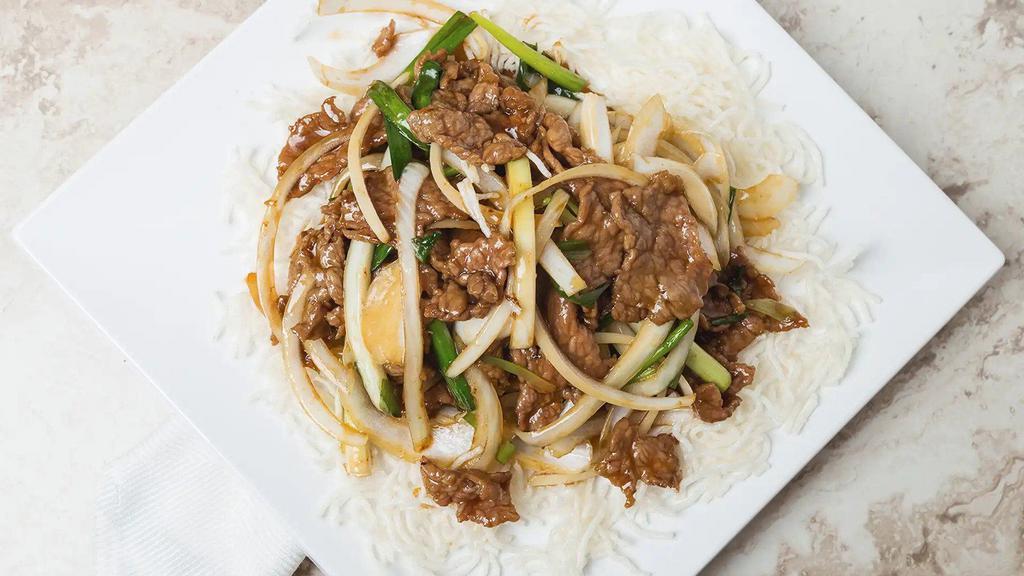 Mongolian Beef / 蒙古牛 · Sliced beef mixed with mushrooms, scallions, onions topped with sesame seeds.  Spicy. With white rice.