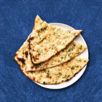 Grace Garlic Naan · Fluffy dough baked in an Indian clay tandoor oven and topped with garlic.