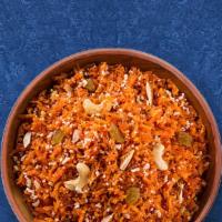 Carrot Halwa · Finely grated carrots slow cooked in a pot with milk, sugar, cardamom and clarified butter.