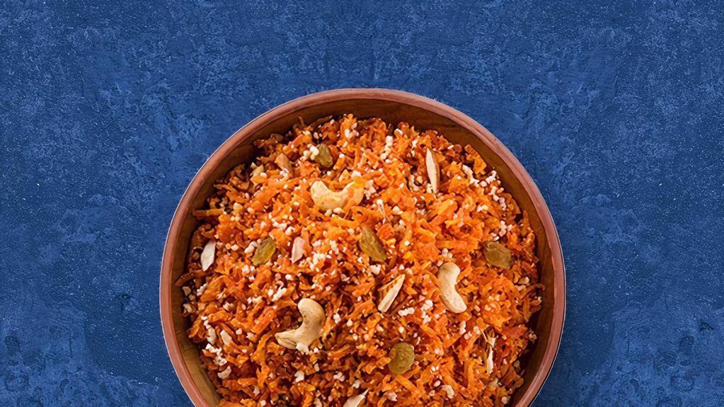 Carrot Halwa · Finely grated carrots slow cooked in a pot with milk, sugar, cardamom and clarified butter.