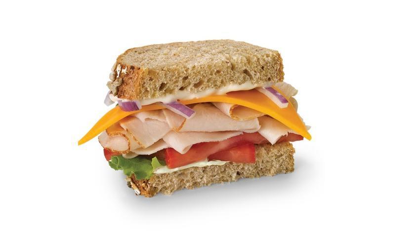 Turkey & Cheddar · Boars head turkey, cheddar cheese, lettuce, tomato and mayo on multigrain bread. come with potato, or macaroni salad.