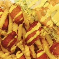Salchipapa · French fries and hot dogs with small salad.
