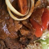 Bistec Encebollado · Sauteed beef with onions and peppers.