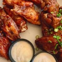 Buffalo Wings · 9 jumbo wings tossed in Frank's Red Hot. Served with a side of blue cheese dressing.