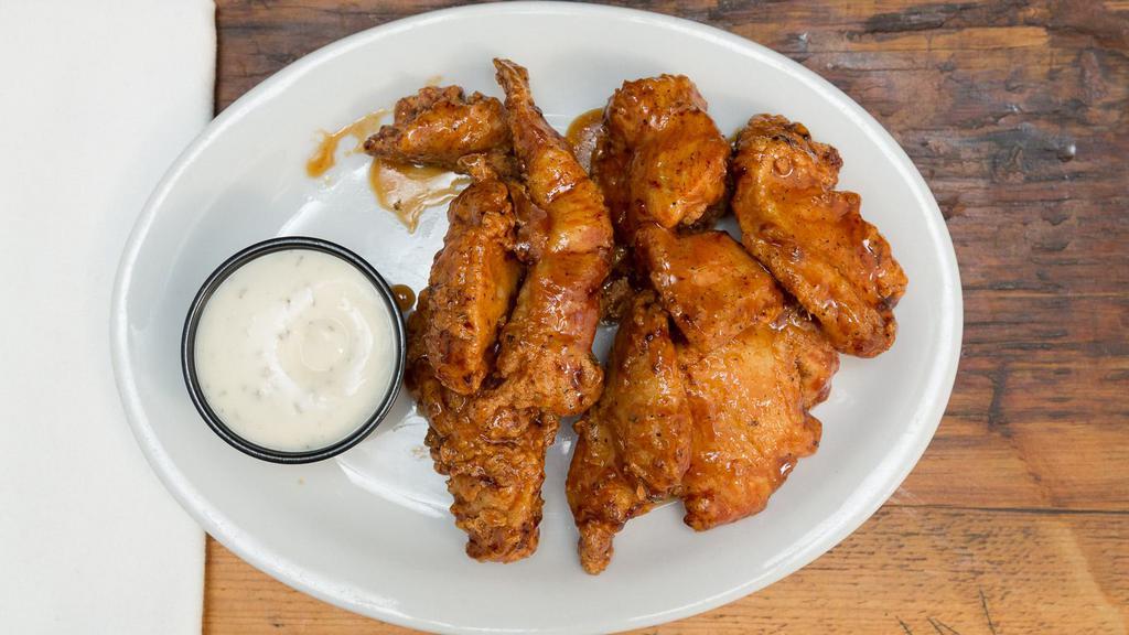 Honey Garlic Wings · 9 jumbo wings tossed in a sweet spicy honey garlic sauce. Served with a side of buttermilk ranch.