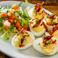 Deviled Eggs · Three (six halves) house made deviled eggs topped with chives and crispy bacon bits. Make it...