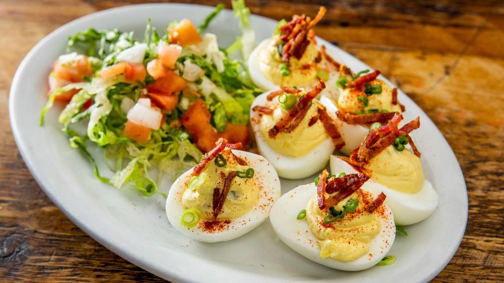 Deviled Eggs · Three (six halves) house made deviled eggs topped with chives and crispy bacon bits. Make it veggie and remove the bacon.