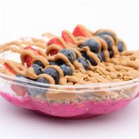 Baya Pitaya · Blended pitaya topped with strawberry, blueberry, granola, coconut shavings, peanut butter.