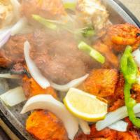 Tandoori Mixed Grill · A combination of our appetizing tandoori chicken, chicken tikka, malai chicken kabab, boti k...
