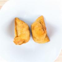 Vegetable Samosa · Fried turnovers deliciously filled with mildly spiced potatoes and peas.