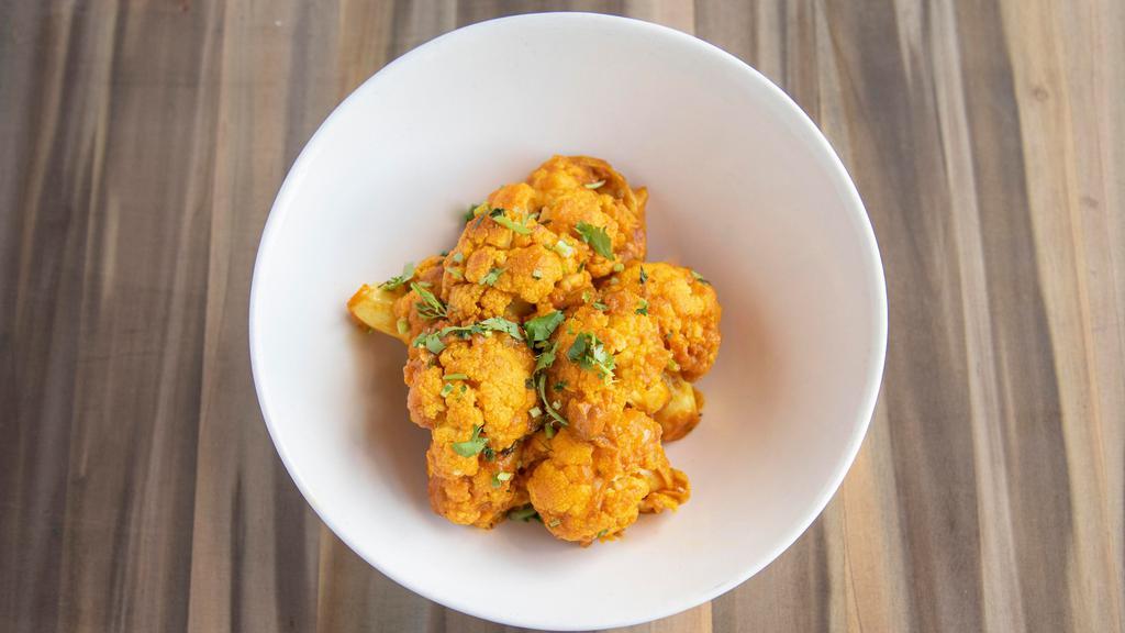 Aloo Gobhi · Fresh cauliflower and potatoes seasoned with Indian spices, cooked to perfection with onions, green peas and tomatoes.