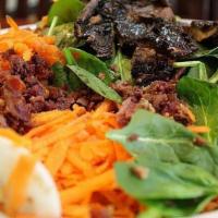 Spinach Salad · Fresh spinach, beef bacon, hard-boiled eggs, portobello mushroom, red onions and shredded ca...