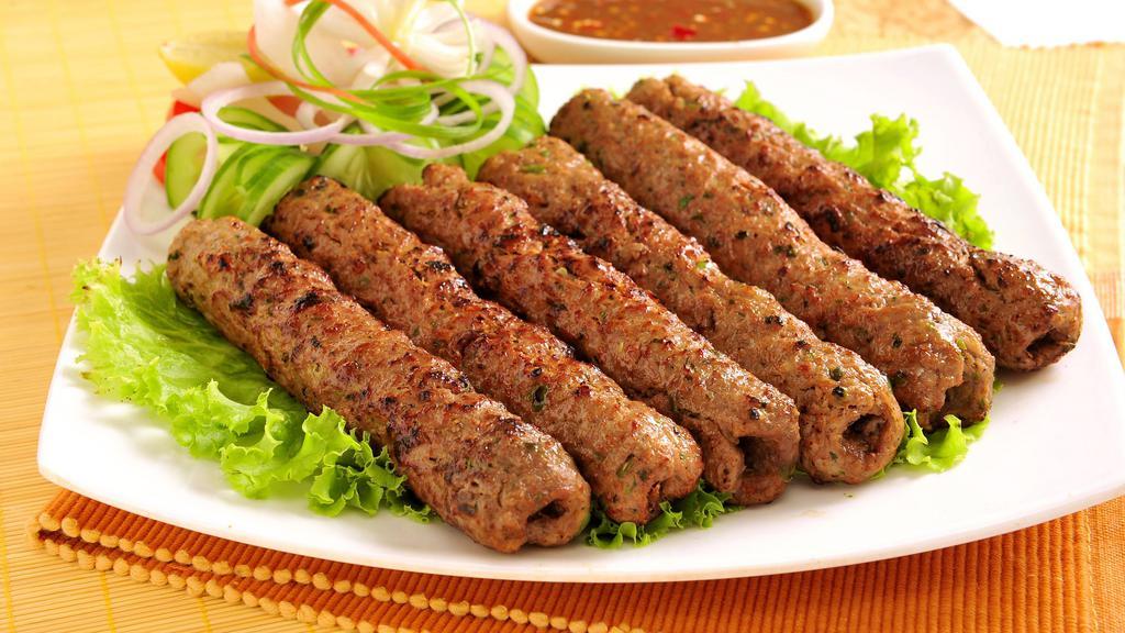 Chicken Seekh Kabab · Oven-baked minced chicken skewers seasoned with onion, garlic, coriander, cumin and exotic spices.