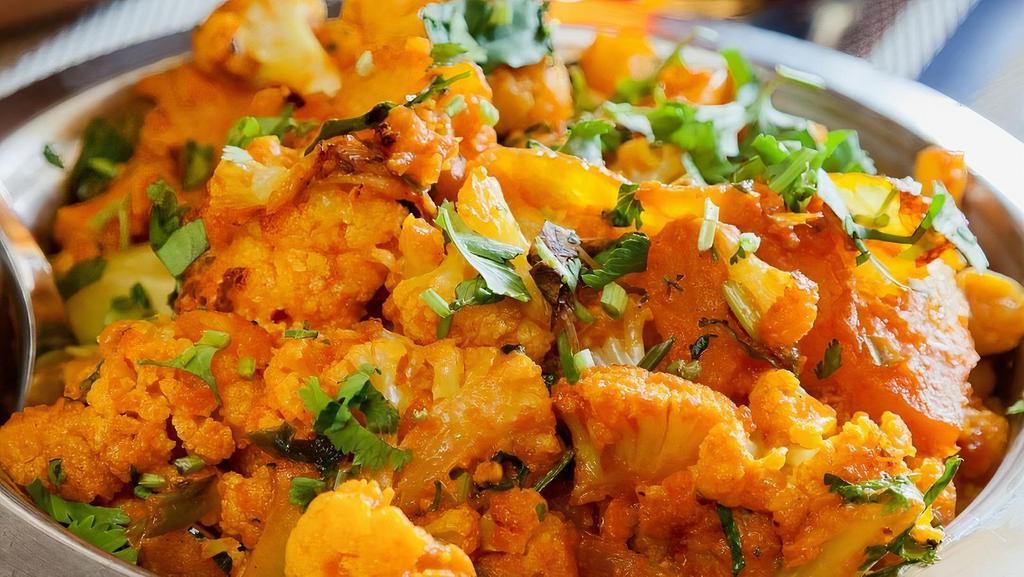 Aloo Gobi · Cauliflower, green peas and potatoes cooked with fresh onions and tomatoes.