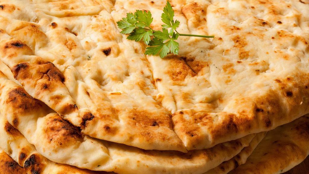 Naan · Bread baked in a clay tandoor oven, great for dipping in the gravy.