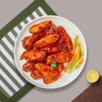 Buffalo Wings · Fresh chicken wings breaded, fried until golden brown, and tossed in buffalo sauce. Served w...