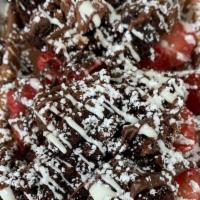 Brownie Fudge Waffle · Brownie bites, strawberry and chocolate, powdered sugar. Waffles are made with milk chocolat...