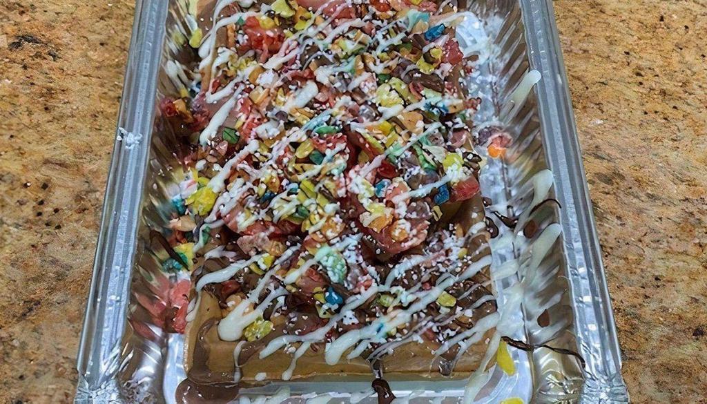 Fruity Pebbles Waffle · Fruity pebbles, strawberry, chocolate and powdered sugar waffles are made with milk chocolate drizzled with white and dark chocolate.