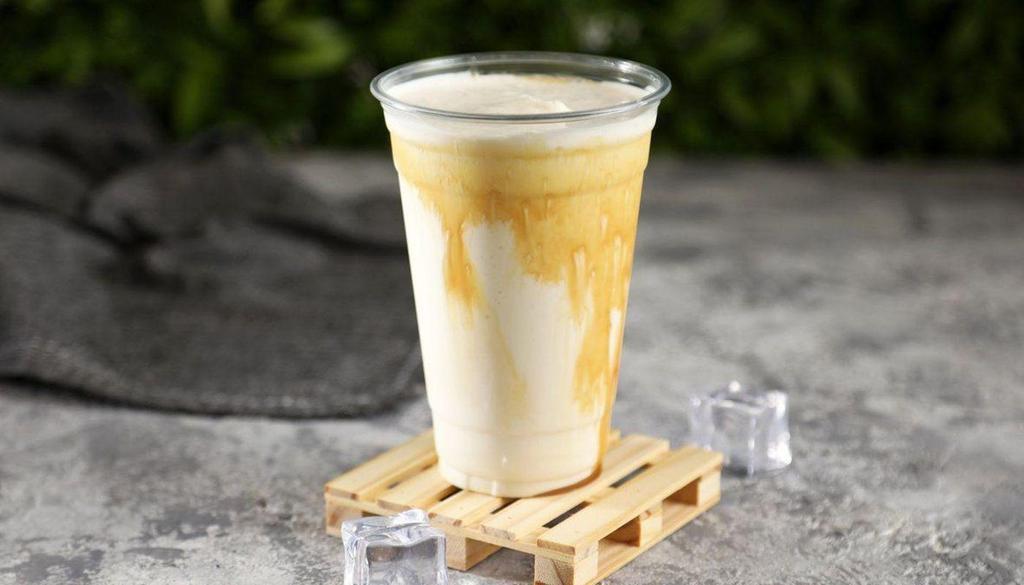 Vanilla Shake · Vanilla ice cream with caramel syrup drizzled on the cup.